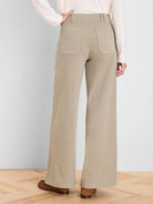 Khaki wide-leg jeans, back view. High waist with belt loops and large rectangular patch pockets on the rear.