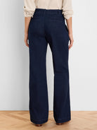 Dark blue wide-leg denim trousers, back view. Features belt loops and two flat rear pockets.