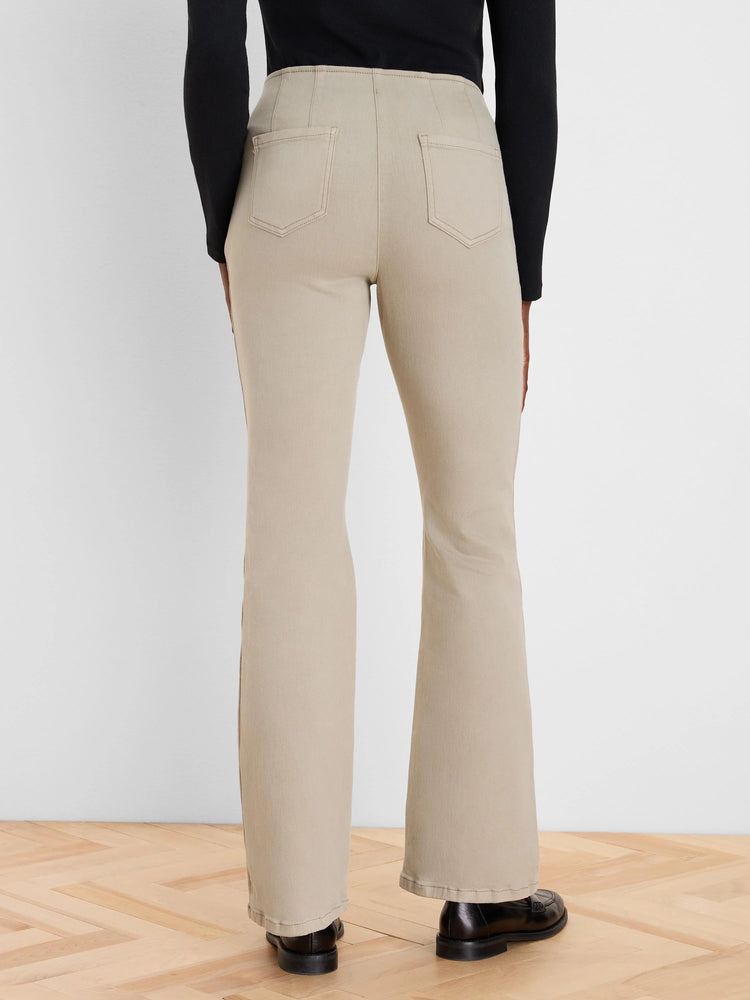 Back view of light beige high-waisted bootcut jeans with two patch pockets and flared legs.