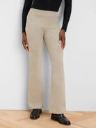 High-waisted, tan bootcut jeans with subtle vertical front seams.