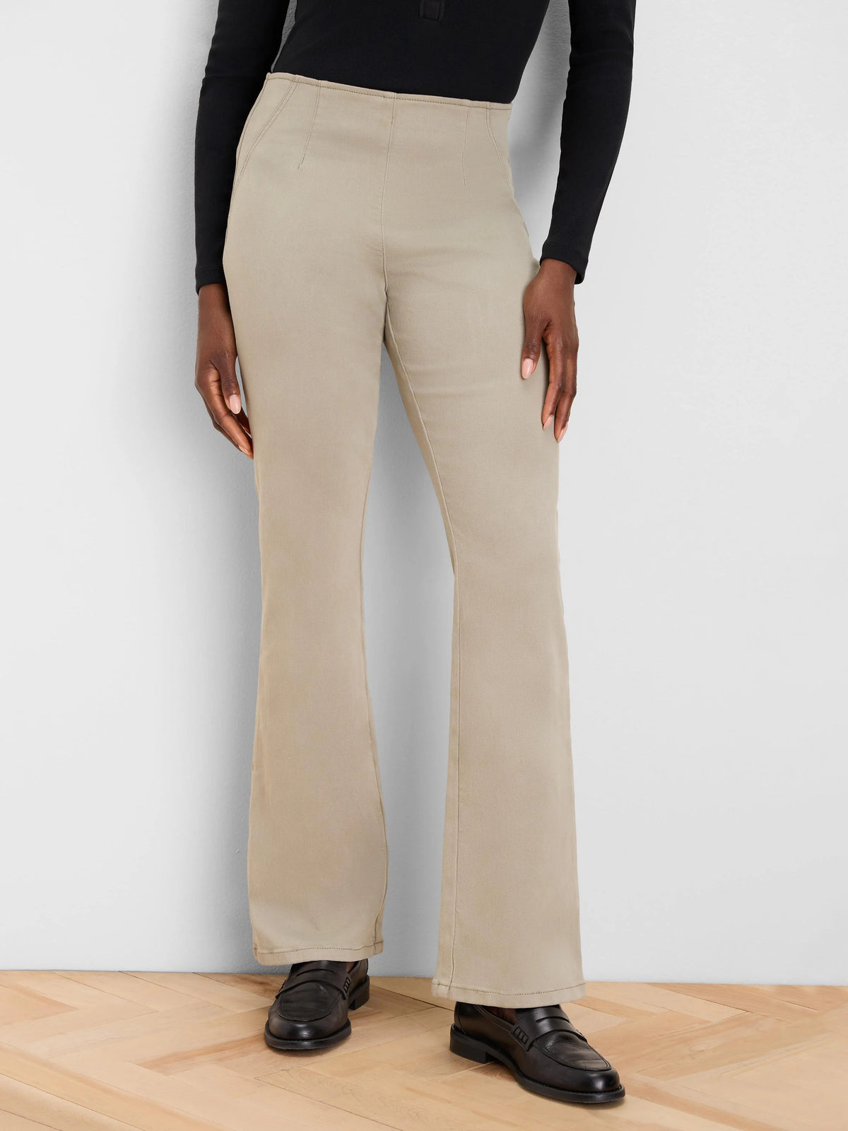 High-waisted, tan bootcut jeans with subtle vertical front seams.