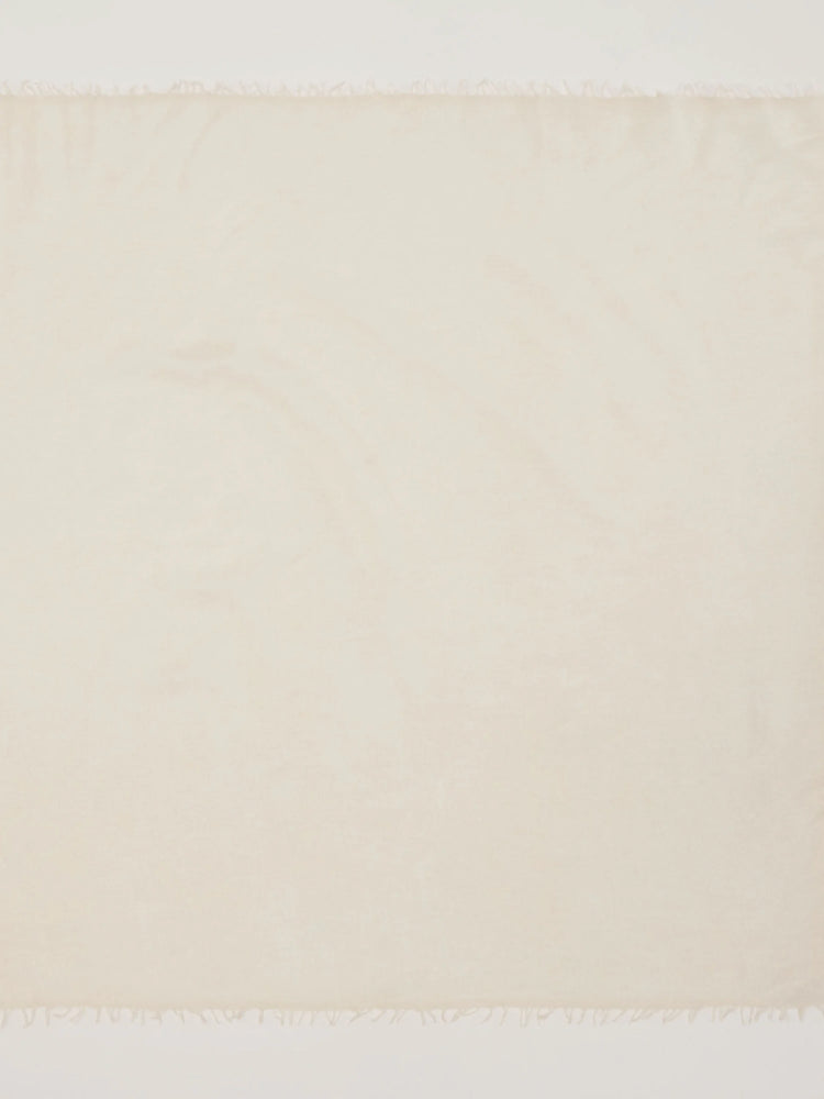 Cream cashmere neck scarf with fringed ends.