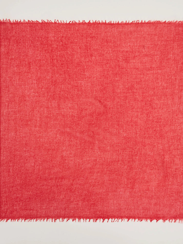 Bright red cashmere neck scarf, lightweight and sheer with a visible textured weave and delicate fringed edges.