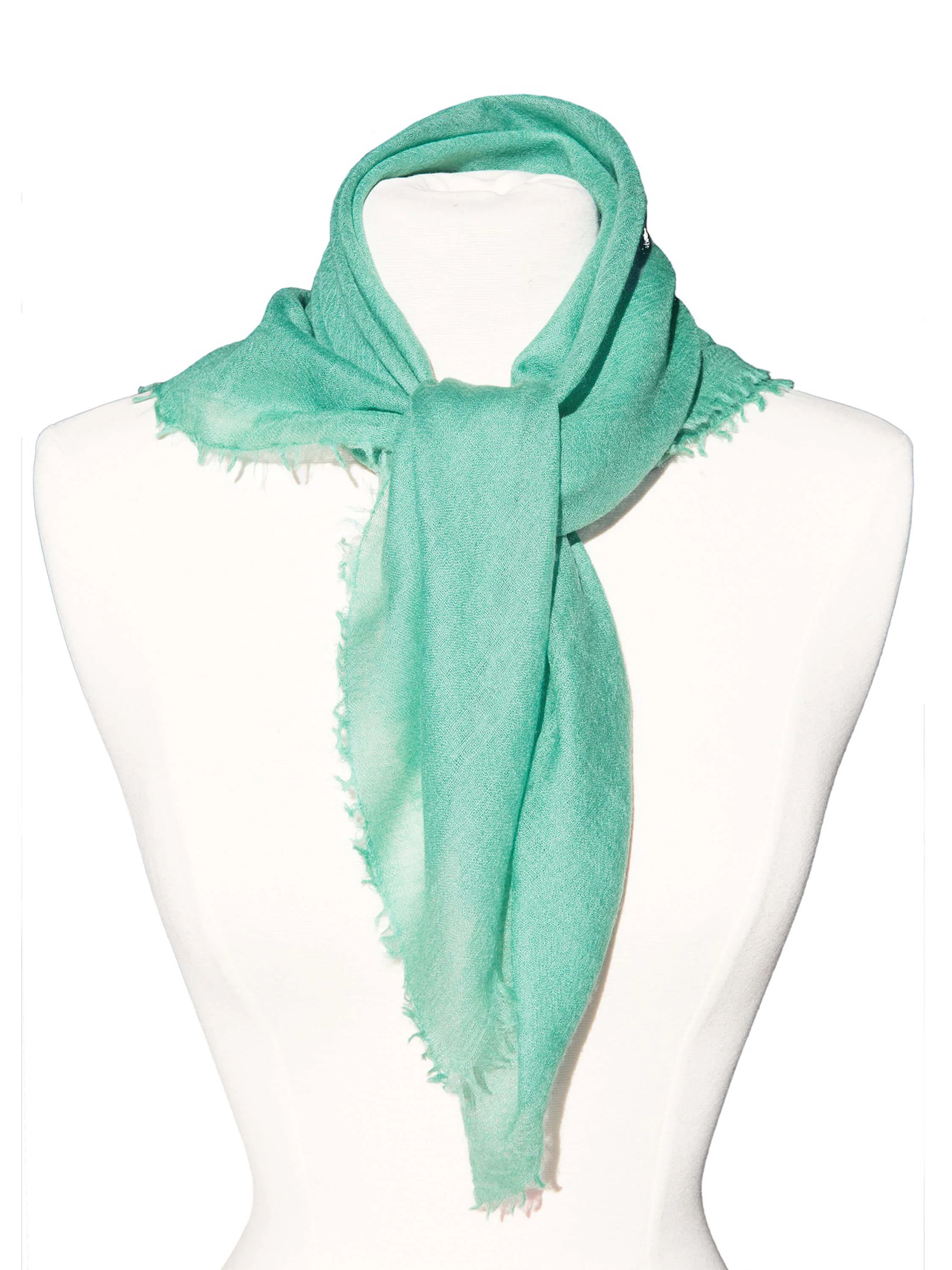 Aqua cashmere neck scarf tied on a mannequin, with frayed edges.
