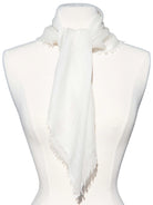 Off-white cashmere neck scarf tied on a mannequin, featuring frayed edges.