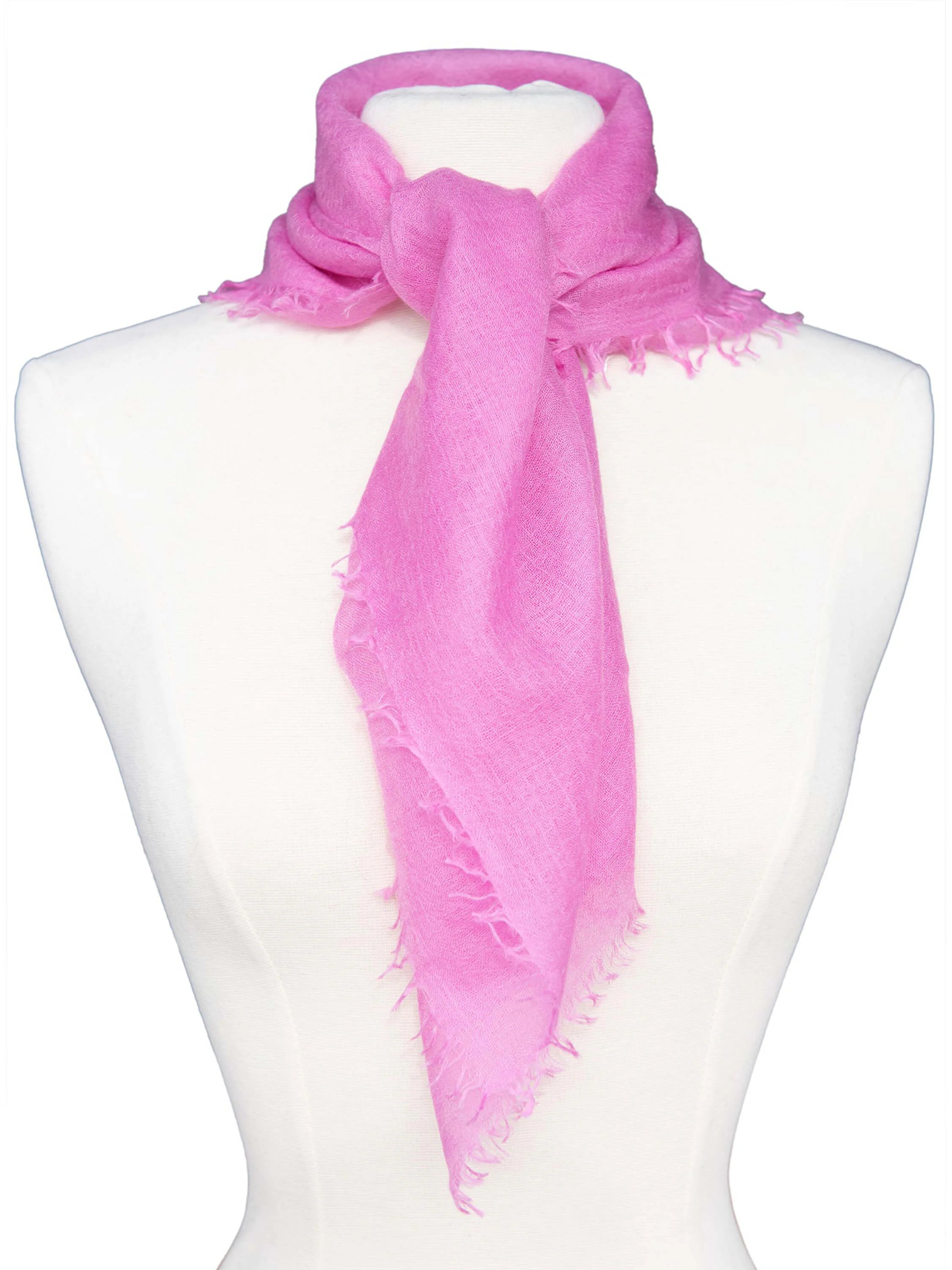 Fuchsia cashmere neck scarf, tied on a mannequin, with frayed edges.