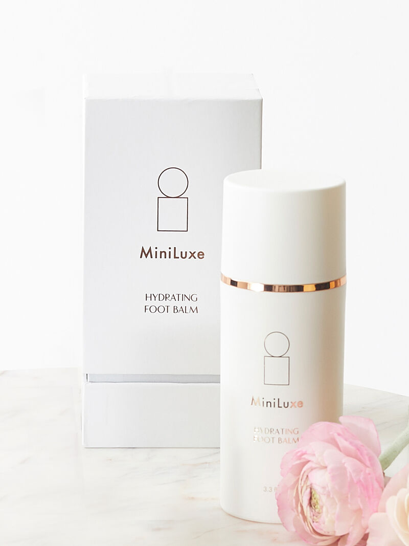 Woman Wears Miniluxe Hydrating Foot Balm image number 0